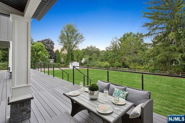 deck featuring outdoor lounge area and a yard