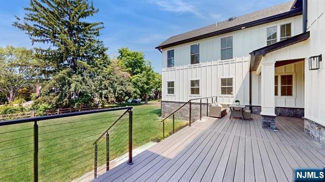 wooden terrace with a lawn