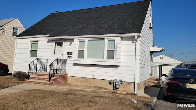 view of front of house with roof with shingles