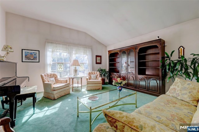 carpeted living area with lofted ceiling