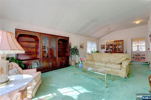 living area with vaulted ceiling, carpet floors, and an inviting chandelier