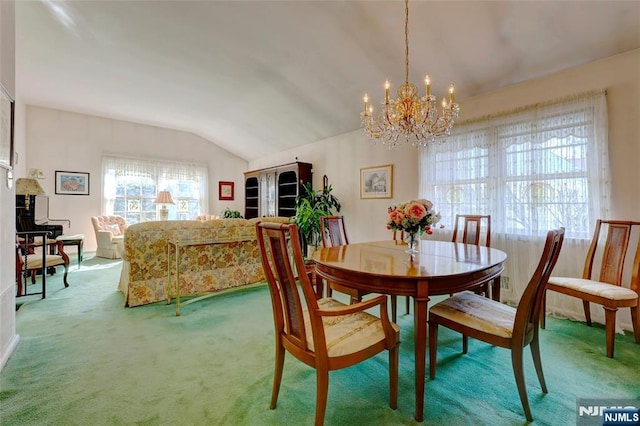 dining room with a notable chandelier, vaulted ceiling, and carpet flooring