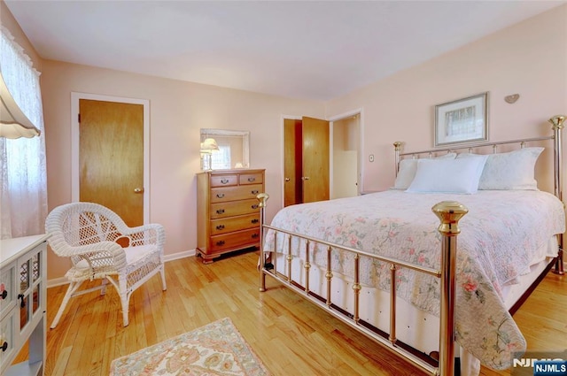 bedroom featuring light wood-style flooring and baseboards