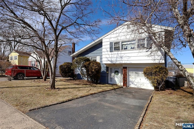 tri-level home featuring brick siding, driveway, and an attached garage