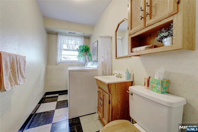 bathroom with visible vents, toilet, vanity, washer / dryer, and tile patterned floors