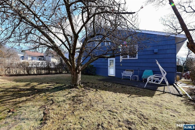 exterior space with a lawn and fence