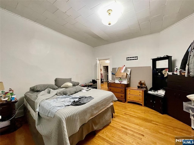 bedroom featuring hardwood / wood-style flooring and ornamental molding