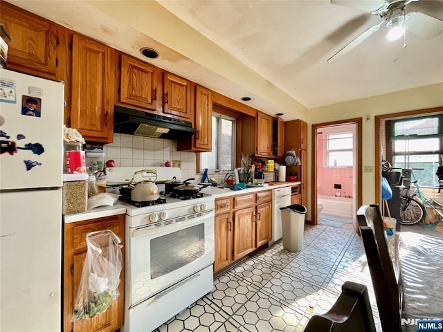 kitchen with ceiling fan, sink, white appliances, and decorative backsplash