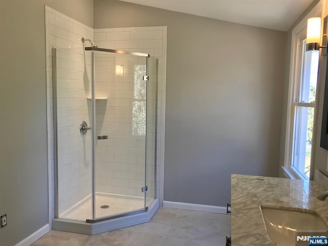 bathroom featuring vanity and a shower with shower door