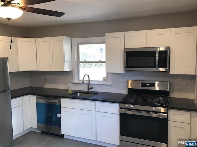 kitchen featuring stainless steel appliances, white cabinetry, and sink