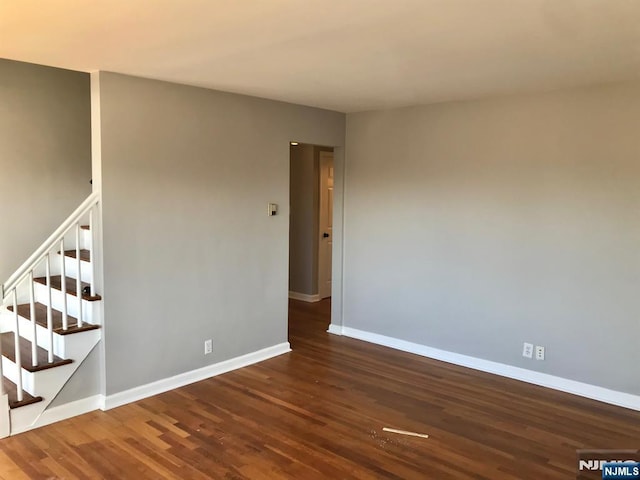 unfurnished room featuring dark wood-type flooring