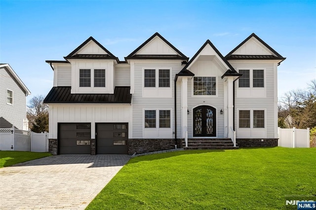 modern farmhouse style home with a garage, a front yard, and french doors