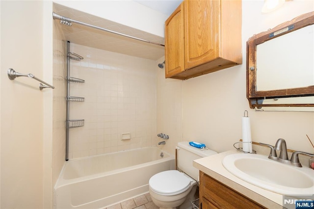 full bathroom with tiled shower / bath, vanity, and toilet