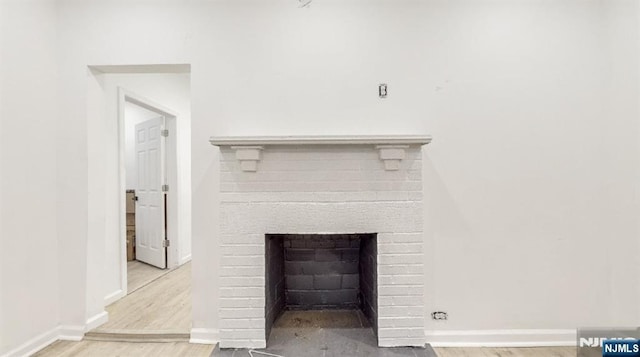 interior details featuring hardwood / wood-style flooring and a fireplace