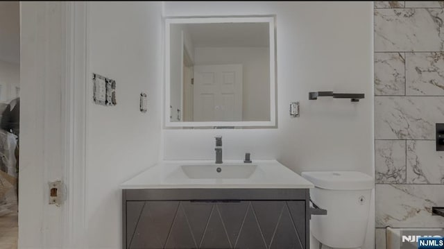 bathroom featuring vanity and toilet