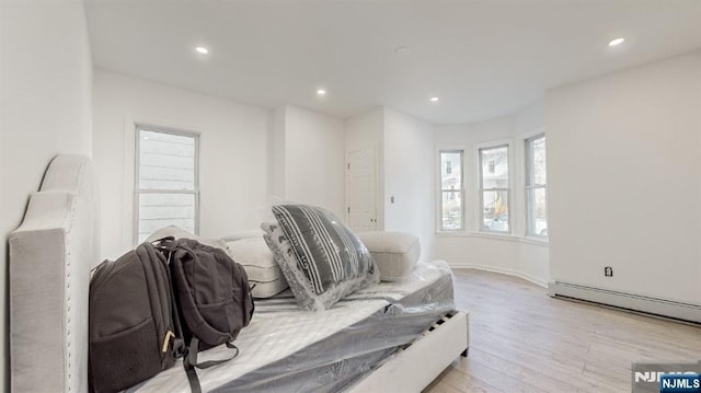 living room featuring light hardwood / wood-style flooring and a baseboard radiator