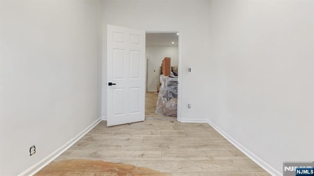 corridor with light hardwood / wood-style flooring