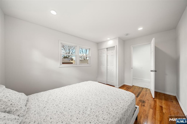 bedroom featuring hardwood / wood-style flooring and a closet