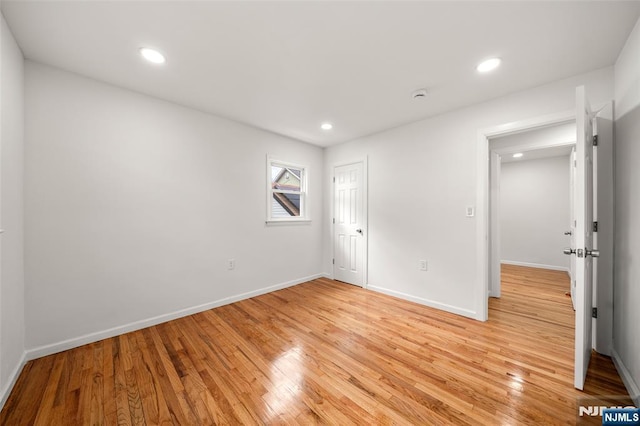 empty room with light hardwood / wood-style floors