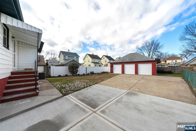 exterior space featuring central AC, a garage, and an outdoor structure