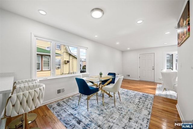 dining space with hardwood / wood-style flooring