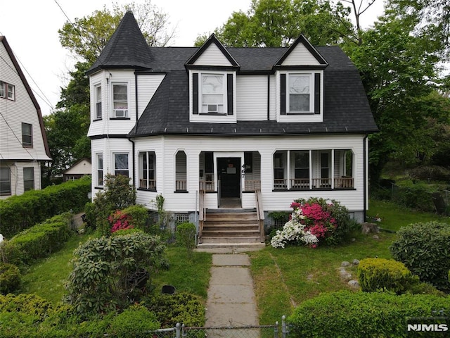 view of front of property with a front yard and covered porch