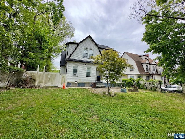 rear view of property with a yard