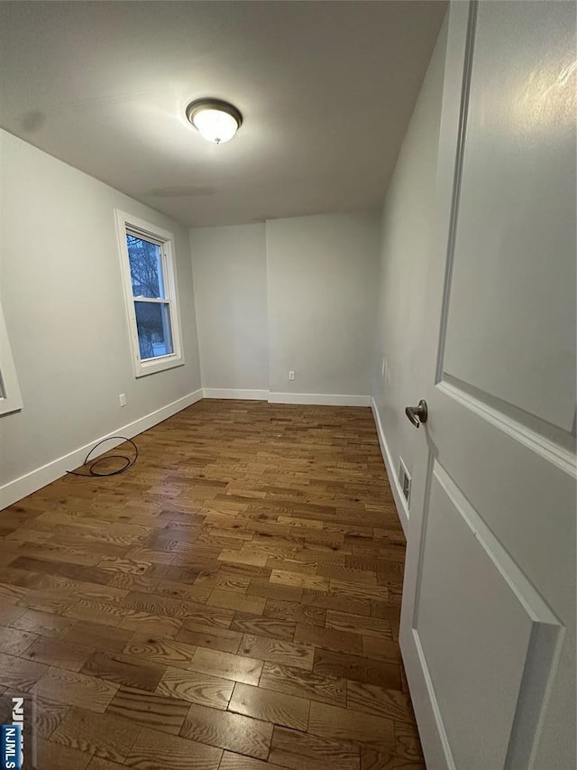 empty room featuring dark hardwood / wood-style floors