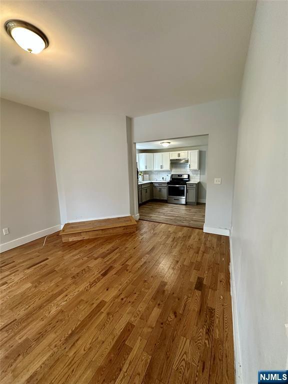 unfurnished living room with hardwood / wood-style floors