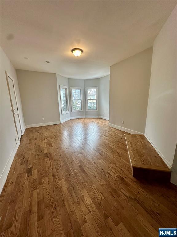 unfurnished room featuring hardwood / wood-style floors