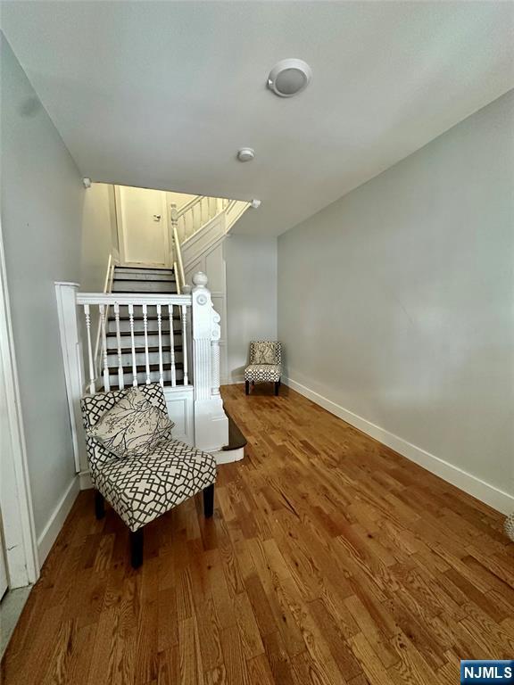 sitting room with wood-type flooring