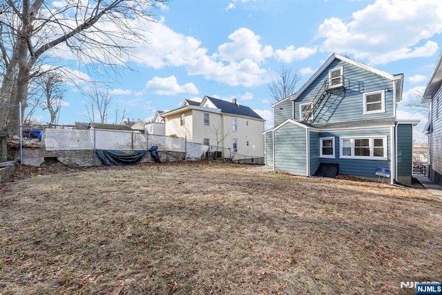 rear view of house with a lawn