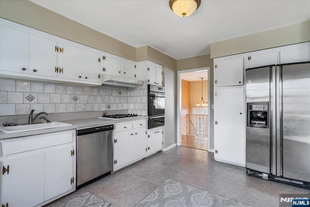 kitchen with white cabinetry, sink, tasteful backsplash, and appliances with stainless steel finishes