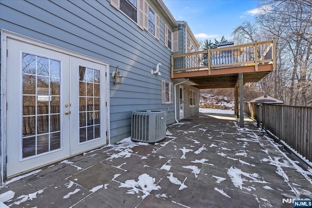 view of patio with french doors, a wooden deck, and cooling unit