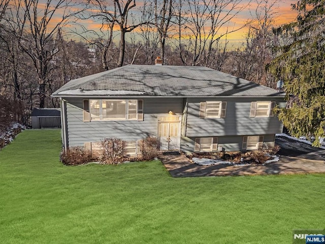 outdoor structure at dusk with a yard