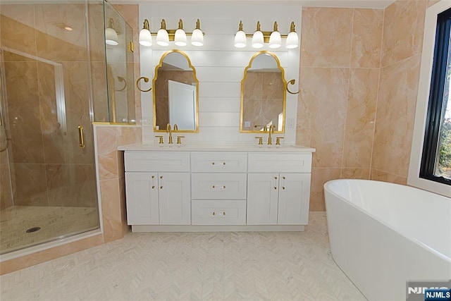 full bath featuring double vanity, a soaking tub, a shower stall, and a sink