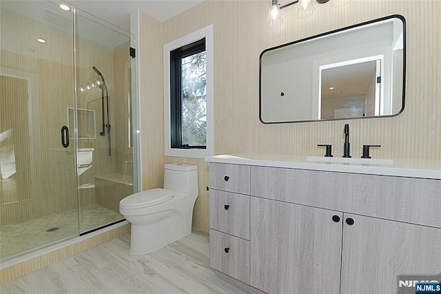 bathroom featuring a stall shower, vanity, and toilet