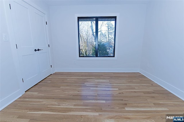 interior space with baseboards and wood finished floors