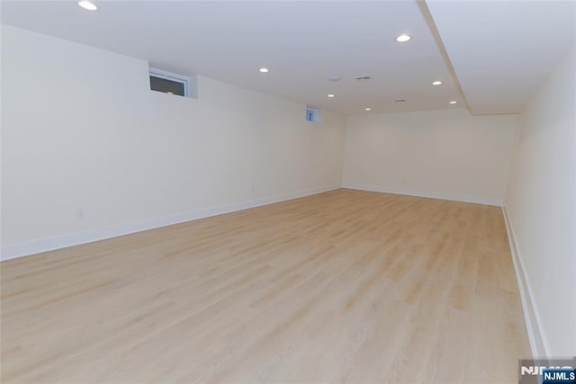 spare room featuring baseboards, light wood-style floors, and recessed lighting