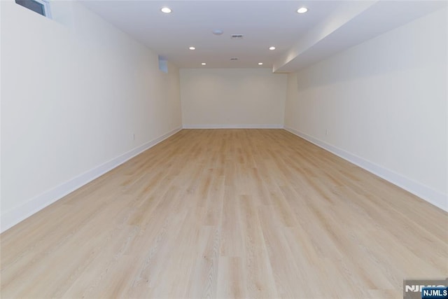 spare room featuring recessed lighting, visible vents, light wood-style flooring, and baseboards