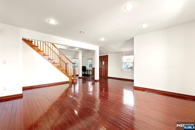 empty room featuring wood-type flooring and a healthy amount of sunlight