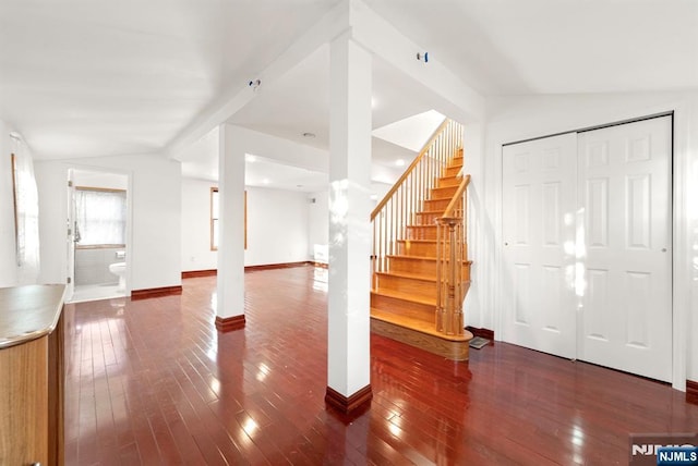 interior space with lofted ceiling and dark hardwood / wood-style floors