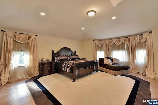 bedroom with wood finished floors and recessed lighting