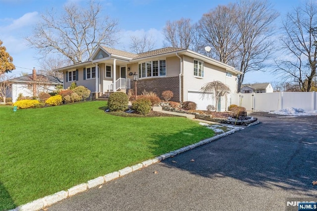 view of front of house with a garage and a front lawn