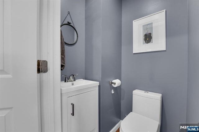 bathroom featuring vanity and toilet