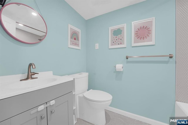 bathroom featuring tile patterned floors, vanity, and toilet