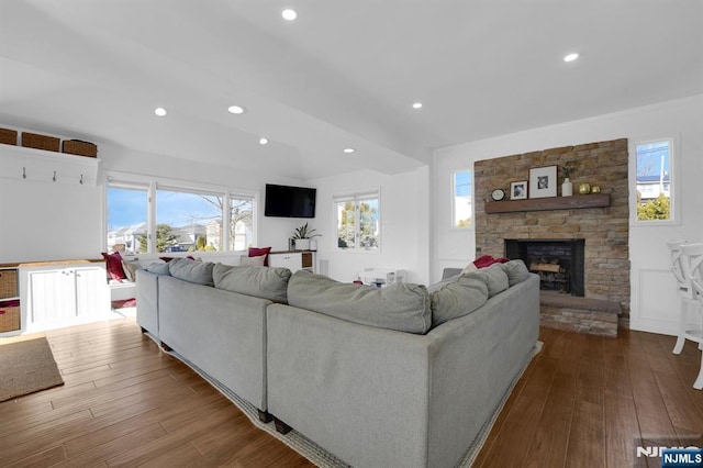 living room with a fireplace and wood-type flooring