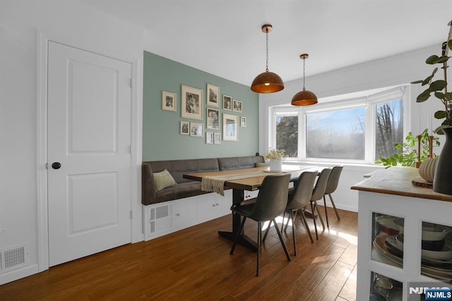 dining room featuring breakfast area and wood-type flooring