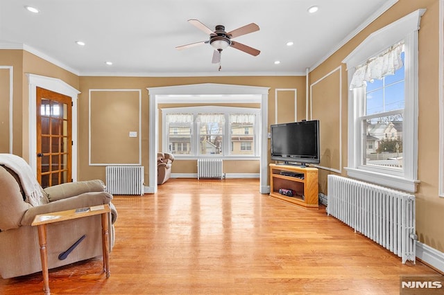 living room featuring radiator and a wealth of natural light