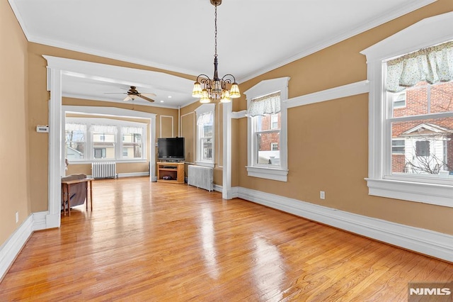 unfurnished living room with ornamental molding, radiator heating unit, and light hardwood / wood-style flooring